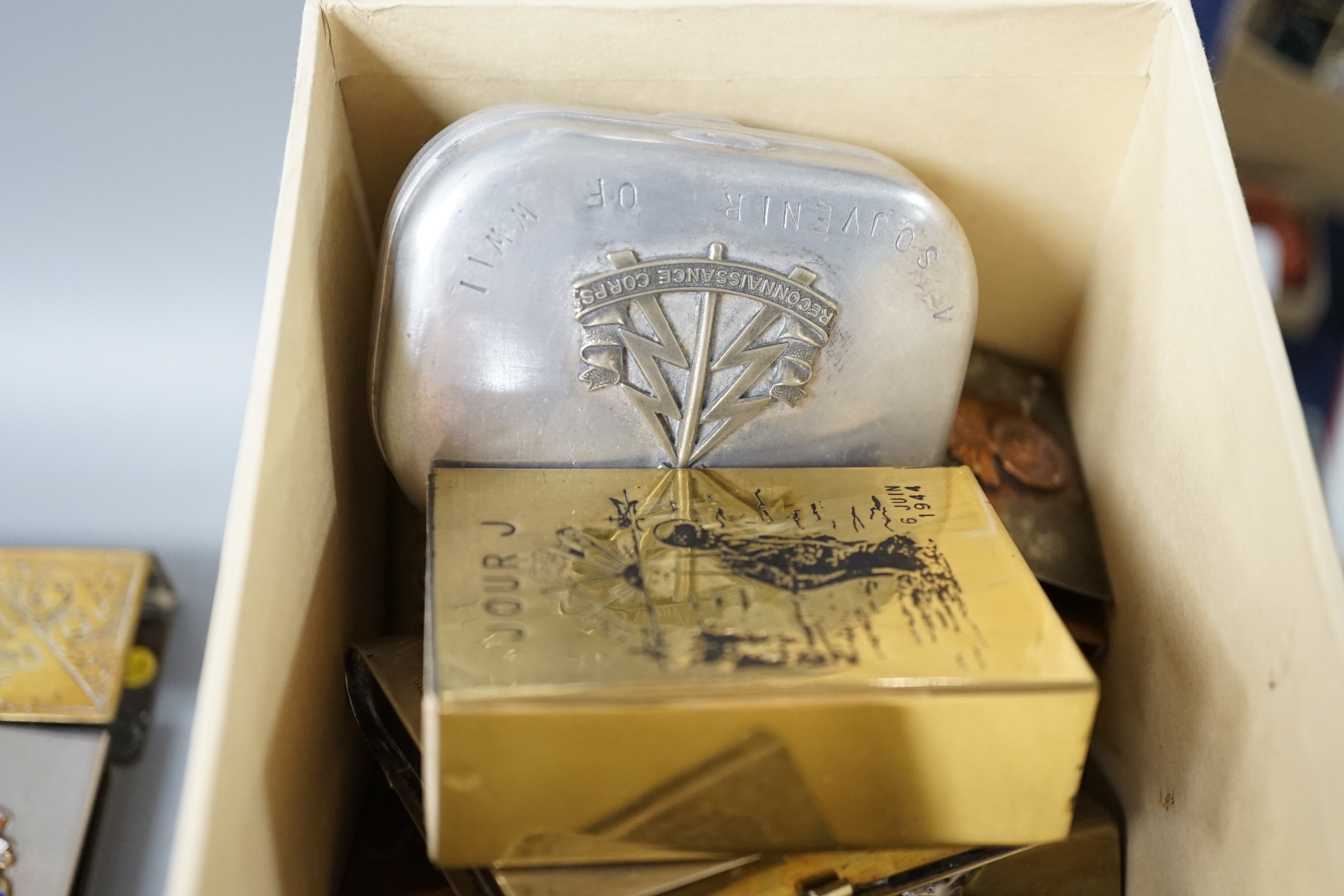 A collection of trench art and military vestas and matchbox holders